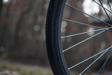 Wheel of the bicycle in the wood background bokeh