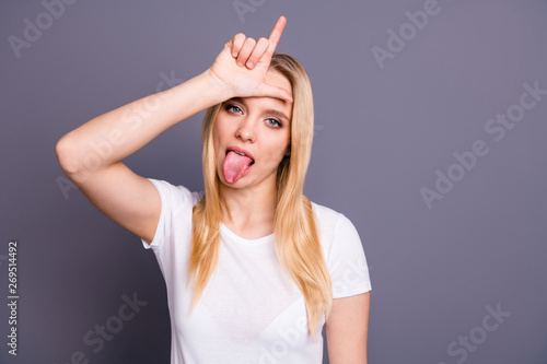 Close up photo beautiful amazing her she lady bad person tongue out mouth showing forehead loser symbol teasing friends impolite wear casual white t-shirt isolated dark grey background