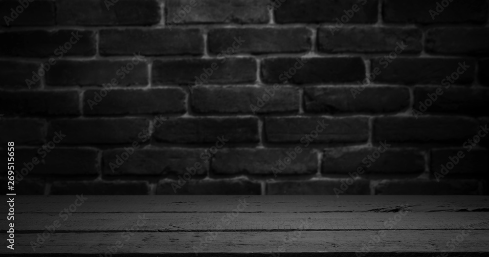 Old wooden table with brick background dark Old wooden table with brick background dark