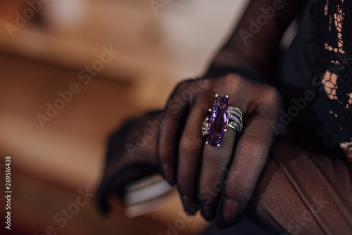 a woman's hand with a ring on which is a large gem