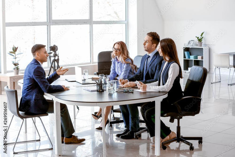 Human resources commission interviewing man in office Human resources commission interviewing man in office