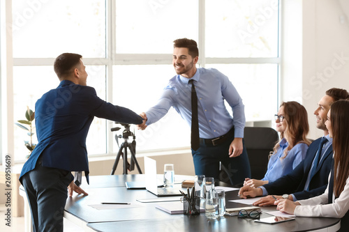 фотографія Human resources manager shaking hands with applicant after successful interview