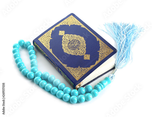 Muslim beads and Koran on white background
