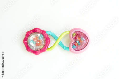 newbor toy. A colorful baby rattle on a white horizontal background photo