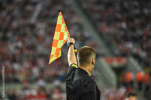 Foto Assistant of football referee raise the flag up.