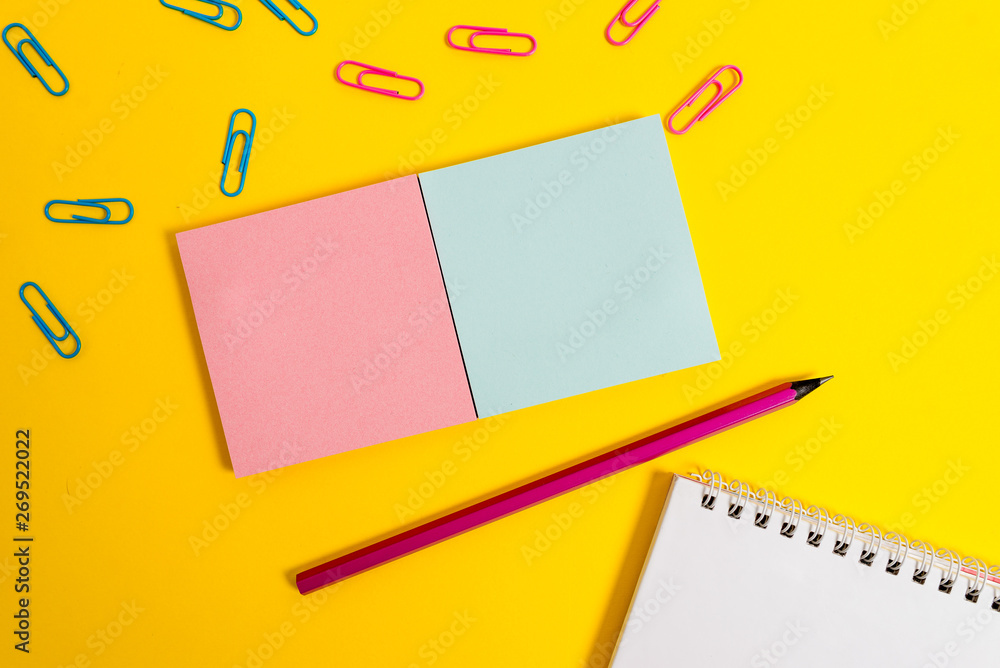 Colored square blank sticky spiral notepads pencil clips color background Colored square blank sticky spiral notepads pencil clips color background
