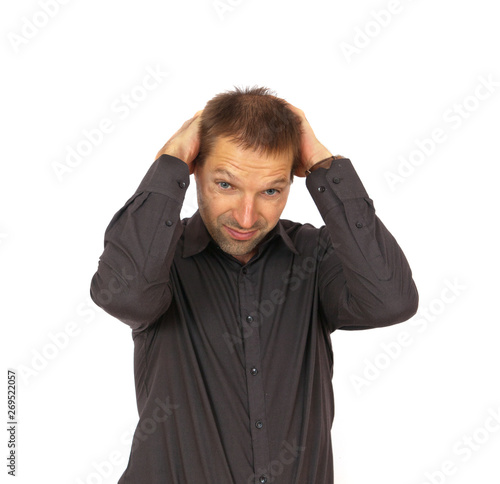 Young man frustrated and holding his head on white background