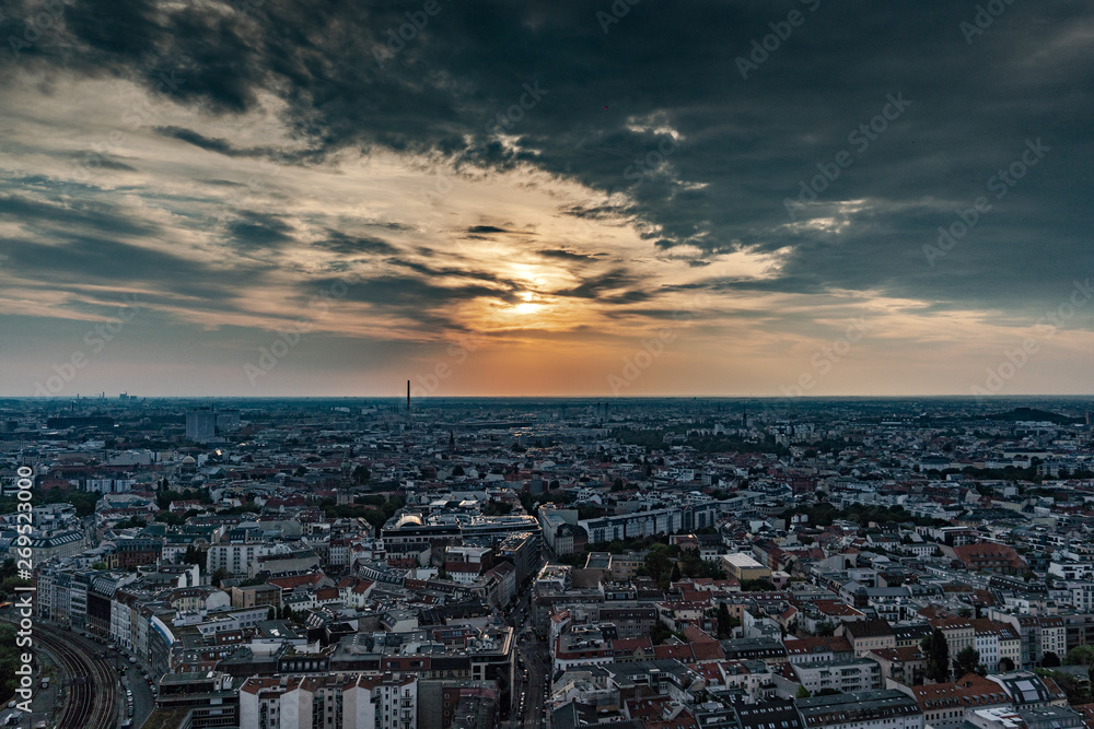Berlin cityscape at sunset during a cloudy sky