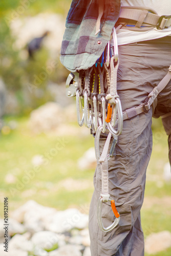 Close-up of a thigh climber with carbines on a belt.