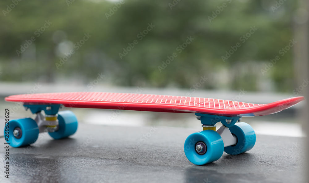 Red skateboard ready for riding at city