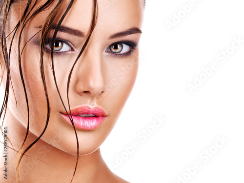 Beautiful face of a woman with dark brown eye makeup