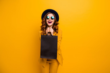 Close up photo beautiful she her lady very glad black friday laughter carry packs perfect look buy buyer birthday sale discount wear specs formal-wear costume suit isolated yellow bright background