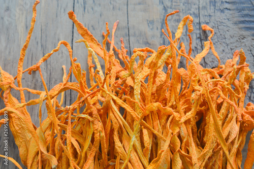 dried cordyceps militaris mushroom flower on wooden background. 