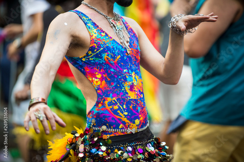 Close-up of an unrecognizable South Asian belly dancer in brightly colored costume with sequined coin belt at a gay pride parade