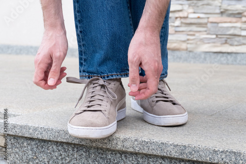 Men's hands tying laces ready for walking