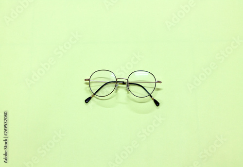 Glasses placed on isolated green background