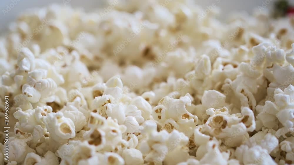 Hands grabbing popcorn from a large bag in slow motion Hands grabbing popcorn from a large bag in slow motion