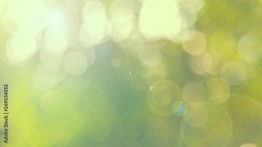 Fototapeta premium Nature yellow bokeh sun light flare and blur leaf abstract texture background, blurred natural green leaves yellow background. Stock image of bokeh light from the sun through the leaves with copyspace