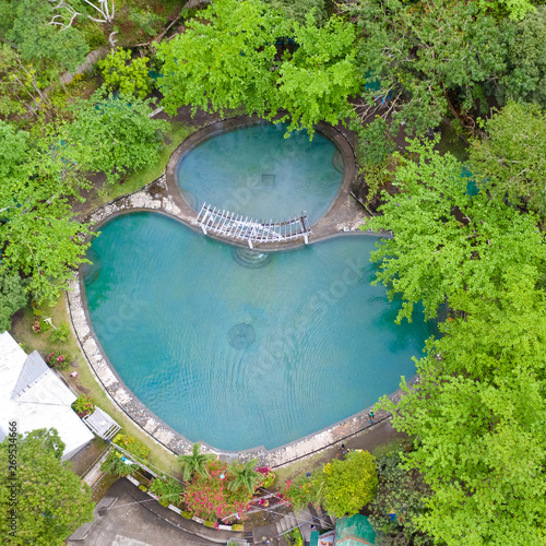Soda Swimming Pool. Swimming pool in tropical forest on Camigin Island, Philippines. Park with swimming pool and soda water for tourists, view from above.