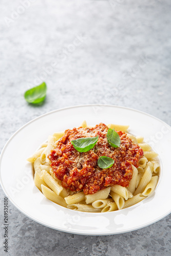 penne pasta with Bolognese sause in white plate