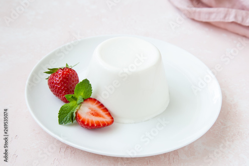 Fotografija Panna cotta, traditional italian dessert, served with fresh strawberry and mint