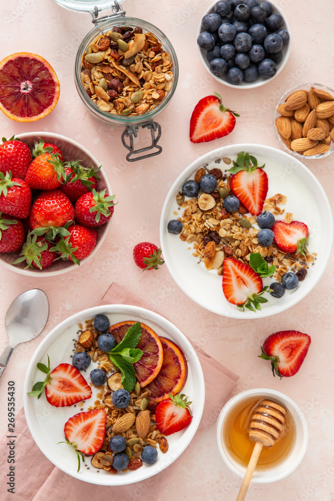 Healthy breakfast concept. Homemade granola, honey, yogurt and fresh berries. Healthy breakfast concept. Homemade granola, honey, yogurt and fresh berries.