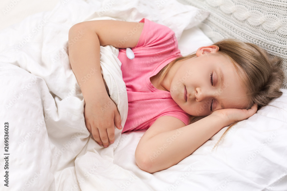 Sick little child girl lying in bed with thermometer. Cold flu season Sick little child girl lying in bed with thermometer. Cold flu season
