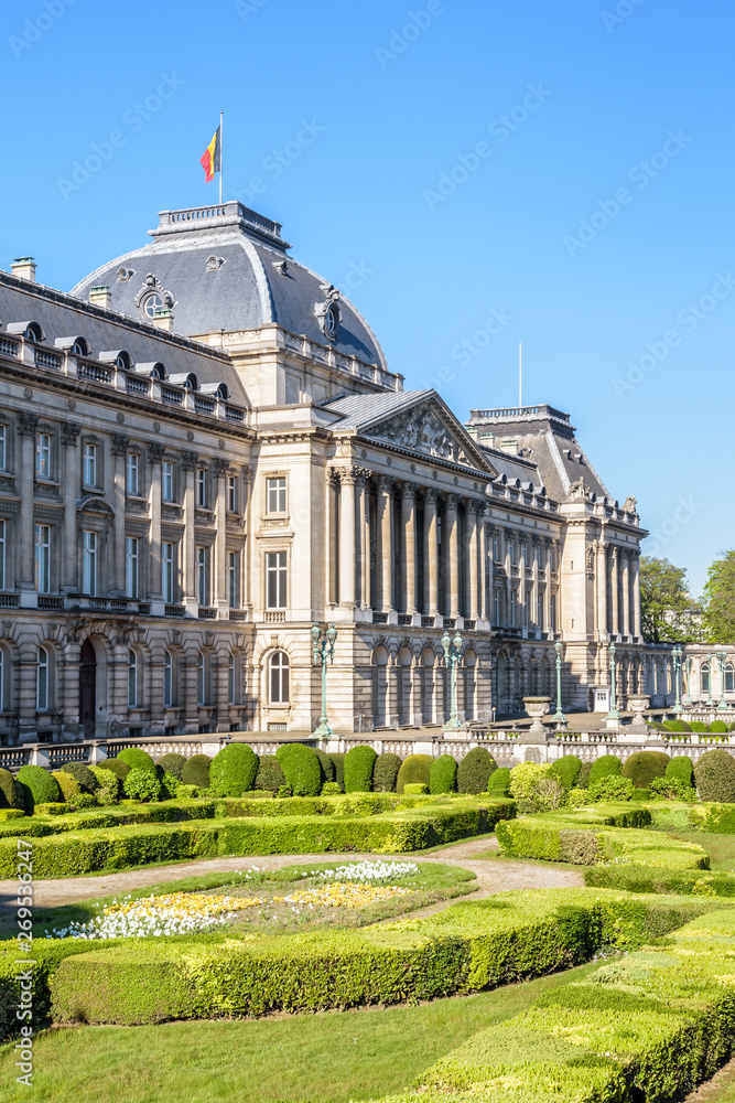 Three-quarter view of the colonnade and formal garden of the Royal Palace of Brussels, the official palace of the King and Queen of the Belgians in the historic center of Brussels, Belgium.