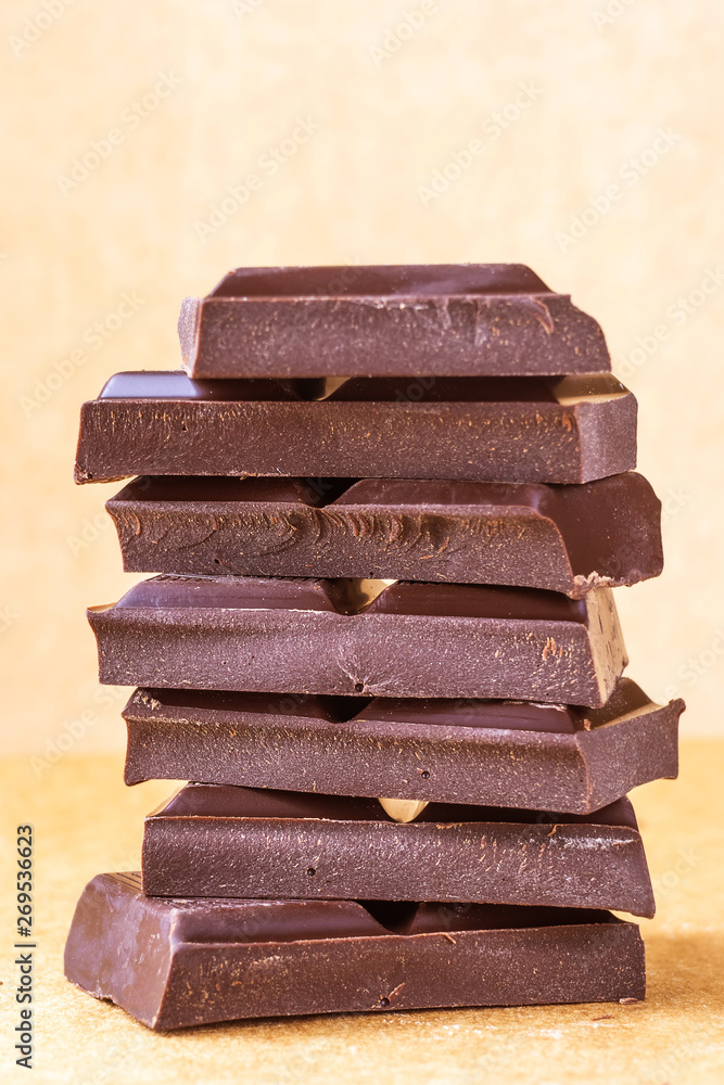 A stack of milk chocolate. Photo in warm colors. Sweetness. World chocolate day A stack of milk chocolate. Photo in warm colors. Sweetness. World chocolate day