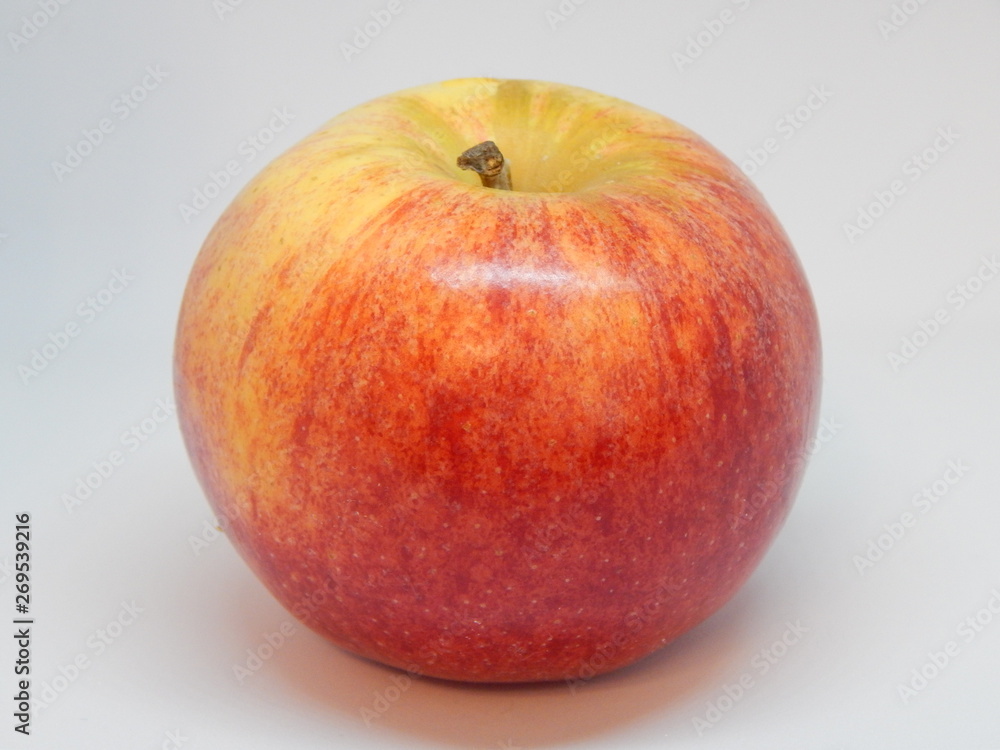 One isolated ripe yellow-red sweet and juicy apple closeup One isolated ripe yellow-red sweet and juicy apple closeup