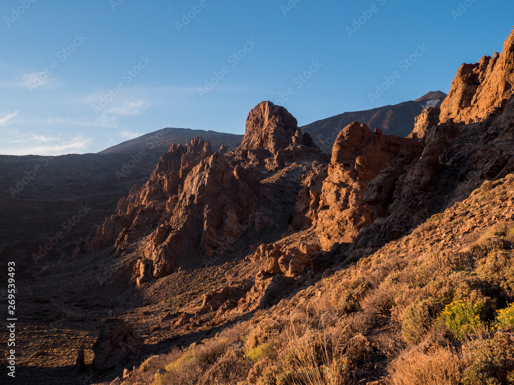 A spot in Tenerife with many rocks and a beautiful mountain landscape in the background
