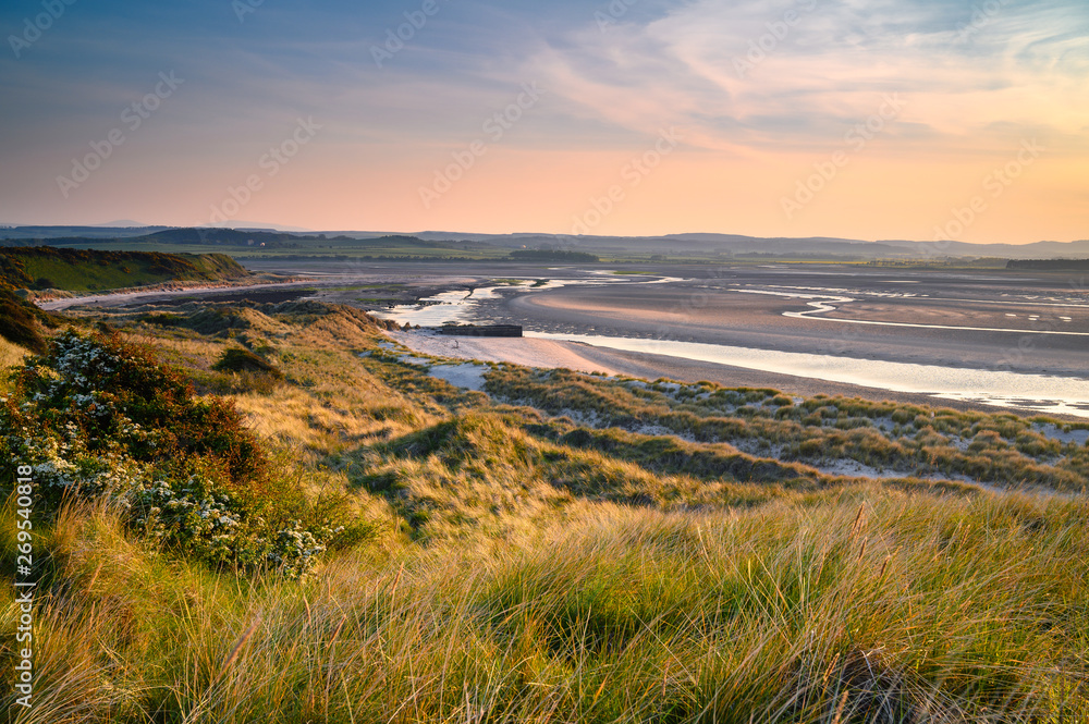 Mud Flats and Dunes at Budle Bay,  at low tide are part of Lindisfarne Nature reserve on Northumberland's AONB coastline