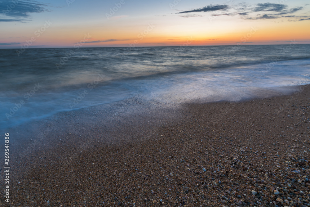 Obraz premium photo on long exposure, waves at sea at sunset