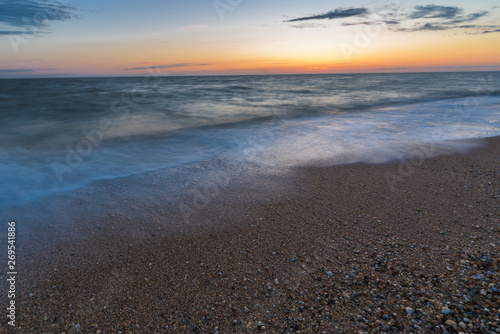 Fototapeta Naklejka Na Ścianę i Meble -  photo on long exposure, waves at sea at sunset