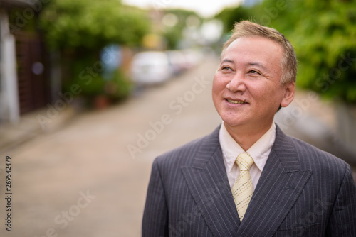 Mature Asian businessman in the streets outdoors © Ranta Images