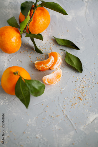 Fresh juicy orange tangerines on blue background close up..Vertical orientation