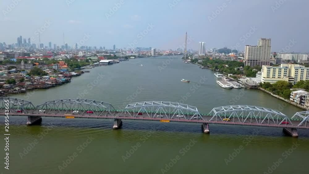 panning left in front of bridge filled with traffic with panoramic view of downtown of Bangkok, Thailand panning left in front of bridge filled with traffic with panoramic view of downtown of Bangkok, Thailand