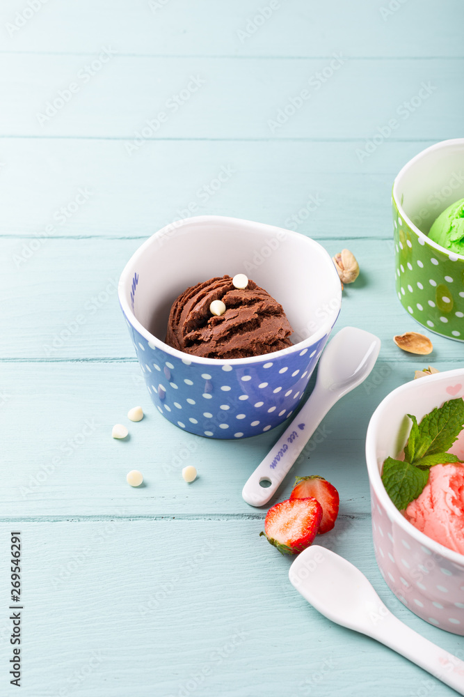 Homemade chocolate ice cream on light blue wooden background. Healthy summer food concept with copy space. Homemade chocolate ice cream on light blue wooden background. Healthy summer food concept with copy space.