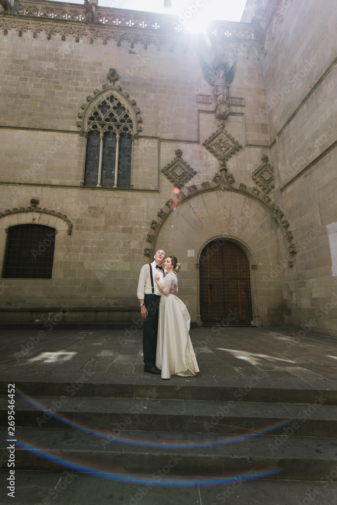 Bride and groom posing on city streets