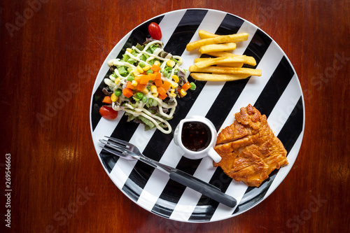 chicken steak served with vegetable salad and french fries - halal food photo