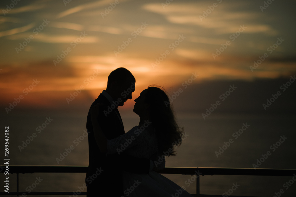 Young beautiful couple on the deck of a cruise liner in the sea