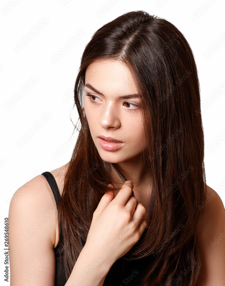 beauty Portrait of a young beautiful brunette girl with brown eyes and straight long flowing hair looking sideways. isolated on white background beauty Portrait of a young beautiful brunette girl with brown eyes and straight long flowing hair looking sideways. isolated on white background