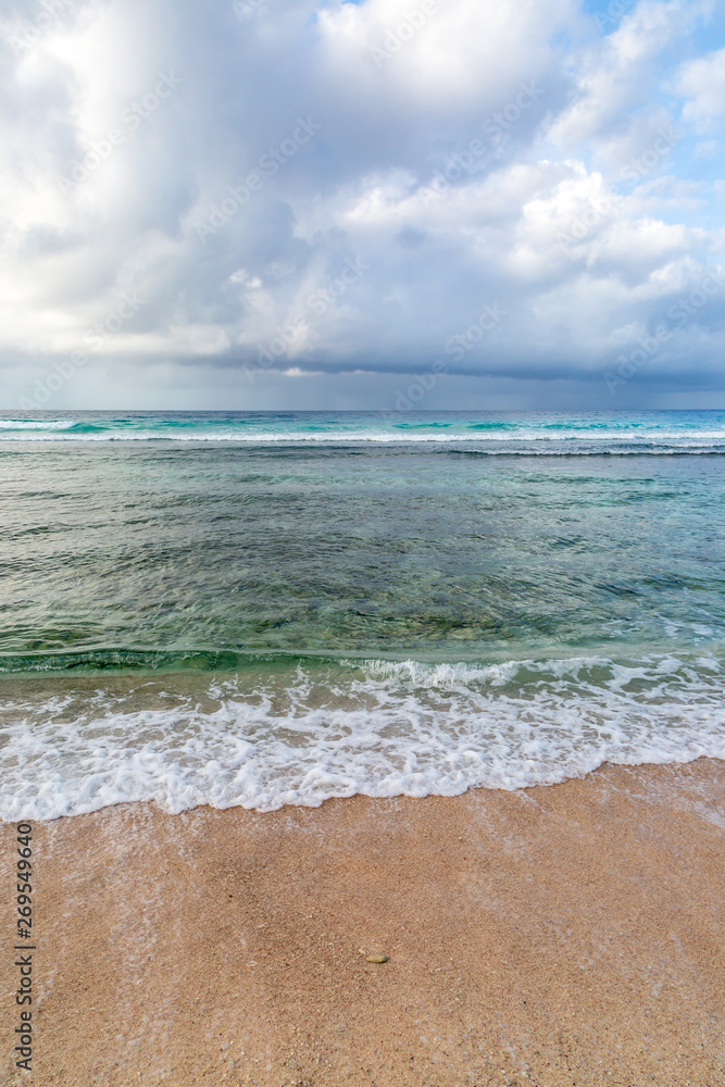 Waves lapping a sandy beach on the Caribbean island of Barbados