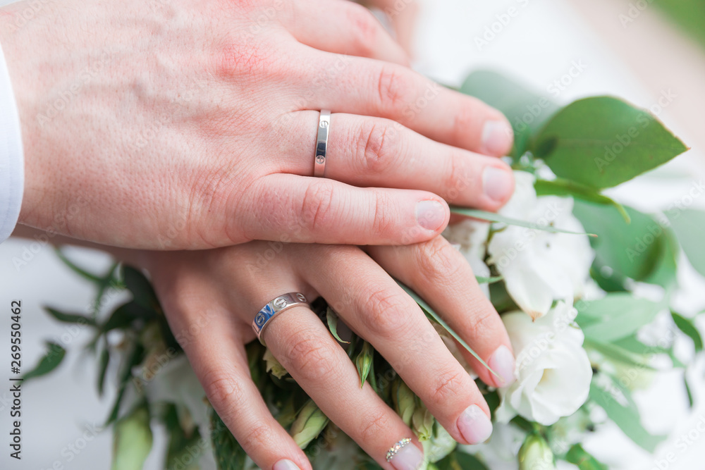 Hand of the groom and the bride with wedding rings Hand of the groom and the bride with wedding rings