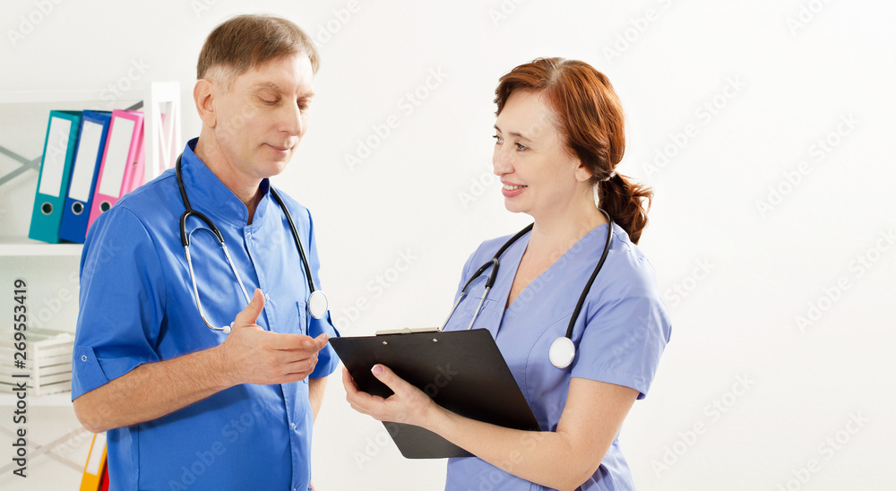 two doctors is diskussion something in medical office clinic, doctor and nurse, medical insurance two doctors is diskussion something in medical office clinic, doctor and nurse, medical insurance