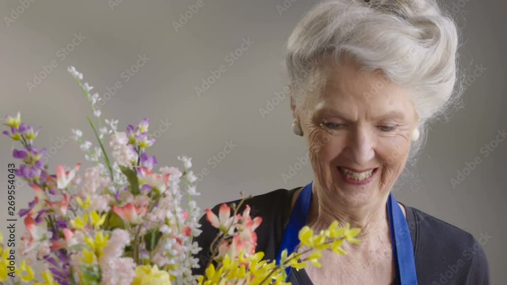 Senior woman making a floral arrangement Senior woman making a floral arrangement