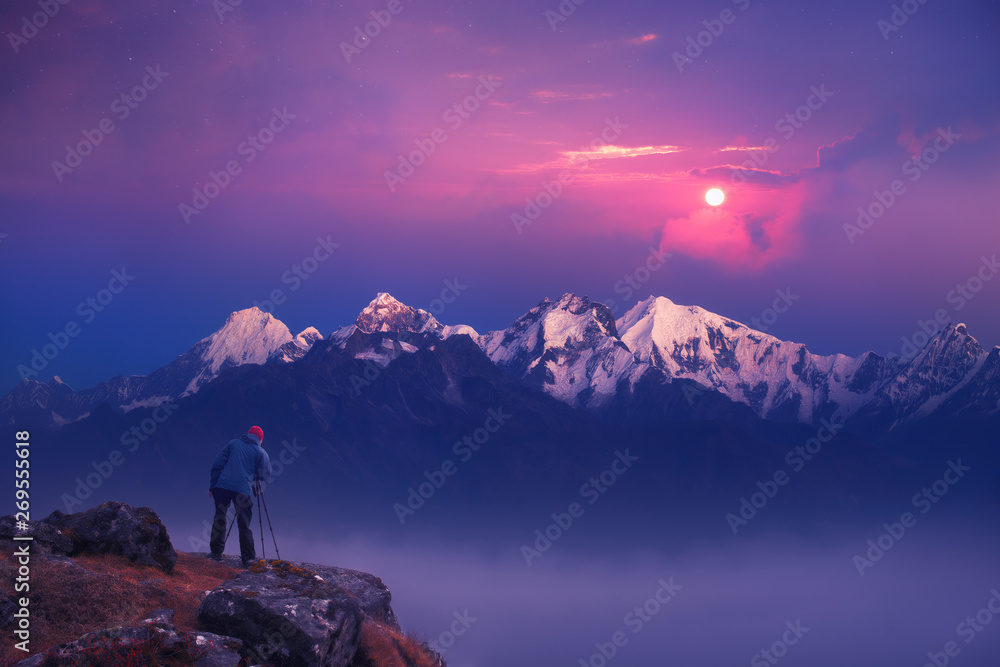 Photographer traveler take a picture of sunrise in mountains the Himalayas. Nepal