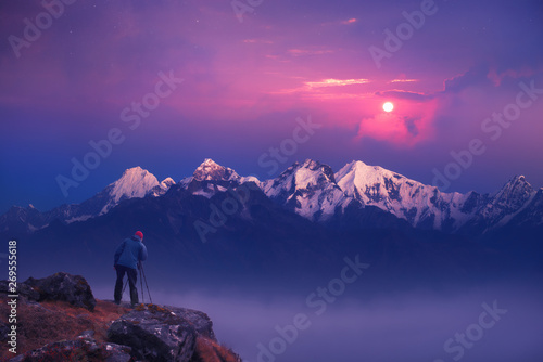Photographer traveler take a picture of sunrise in mountains the Himalayas. Nepal
