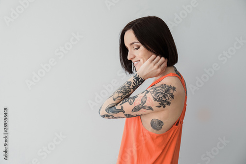 Stylish tattooed woman on l...