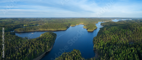 Aerial drone view of blue lakes and green forests. Beautiful summer panorama. National park in Finland. © raland
